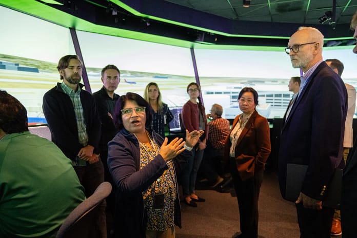 NASA Savvy Verma, left, and Huy Tran, director of aeronautics at NASA’s Ames Research Center in California’s Silicon Valley, center, explain a recent air traffic management simulation to guests at Ames’ FutureFlight Central simulator.